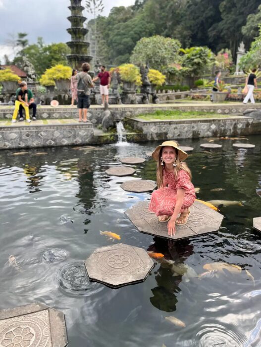 Dr. Maia in pink dress by pond