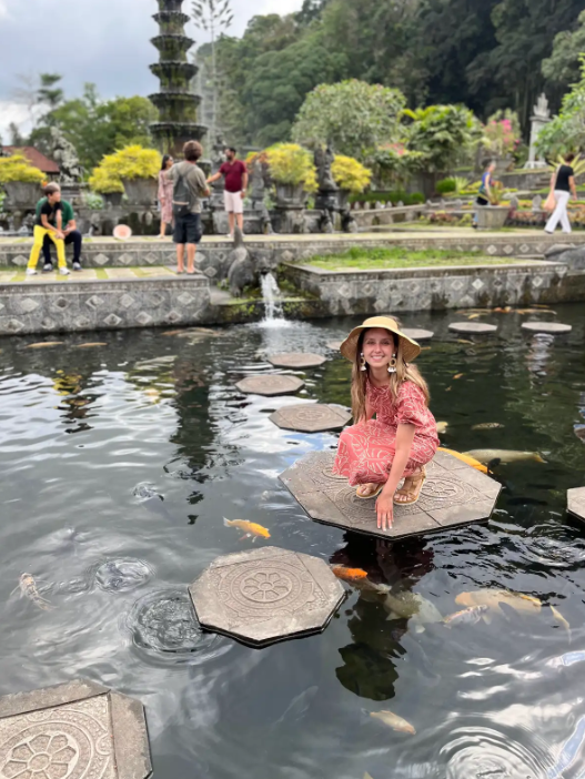 Dr. Maia in pink dress by pond