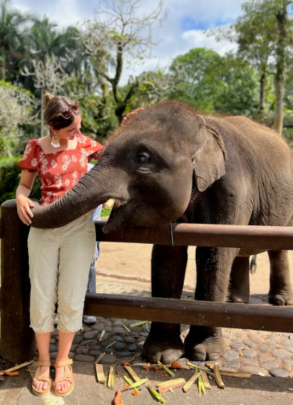 Woman interacting with an elephant.