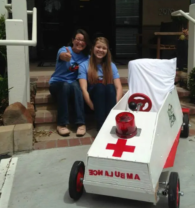 Two girls with a toy ambulance.