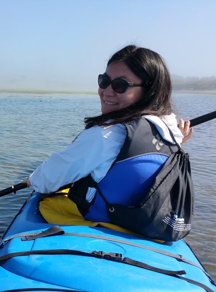 Dr. Angela kayaking through lake
