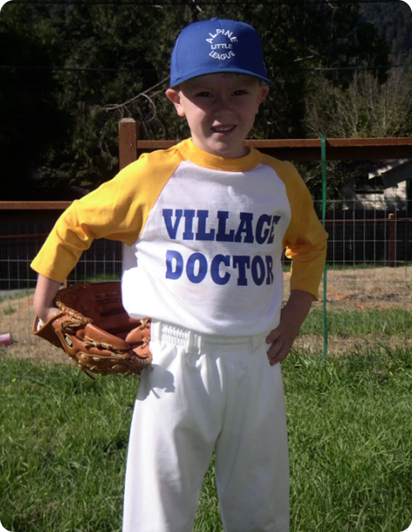 Child in baseball uniform posing confidently