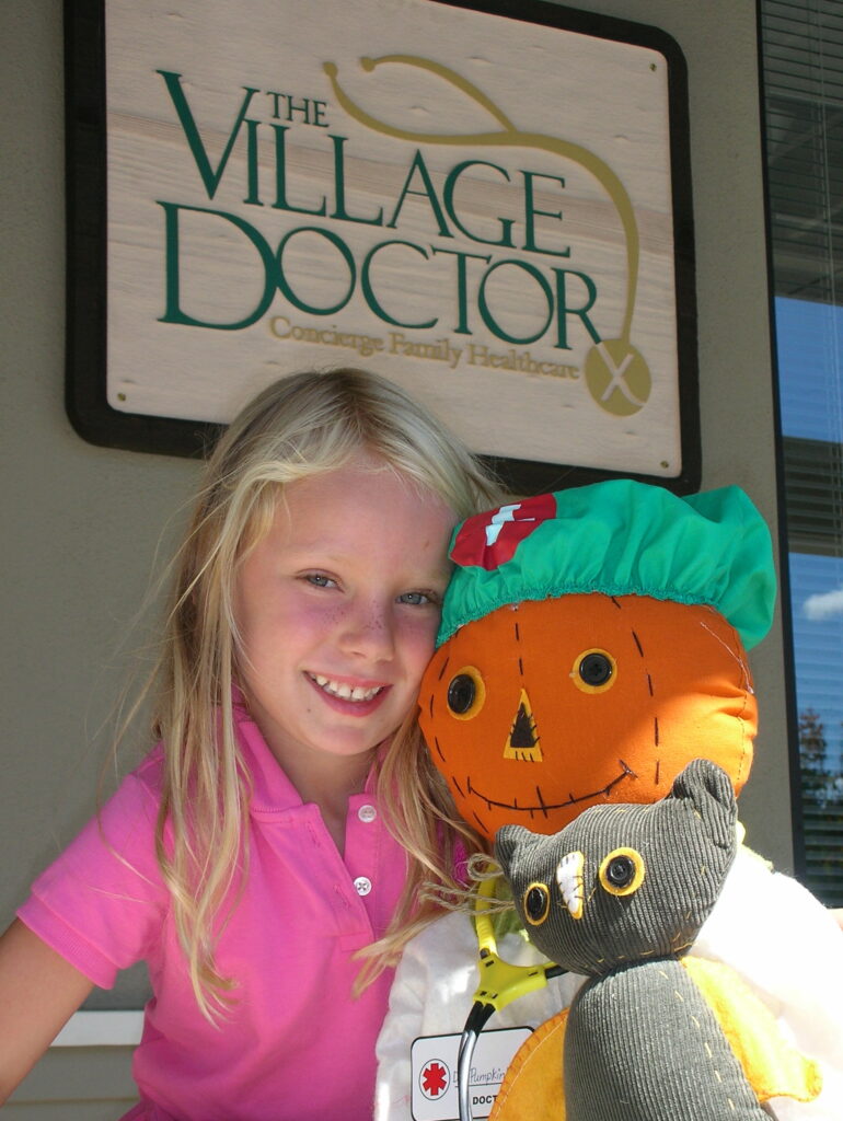 Lucy with pumpkin-doctor and stuffed animal