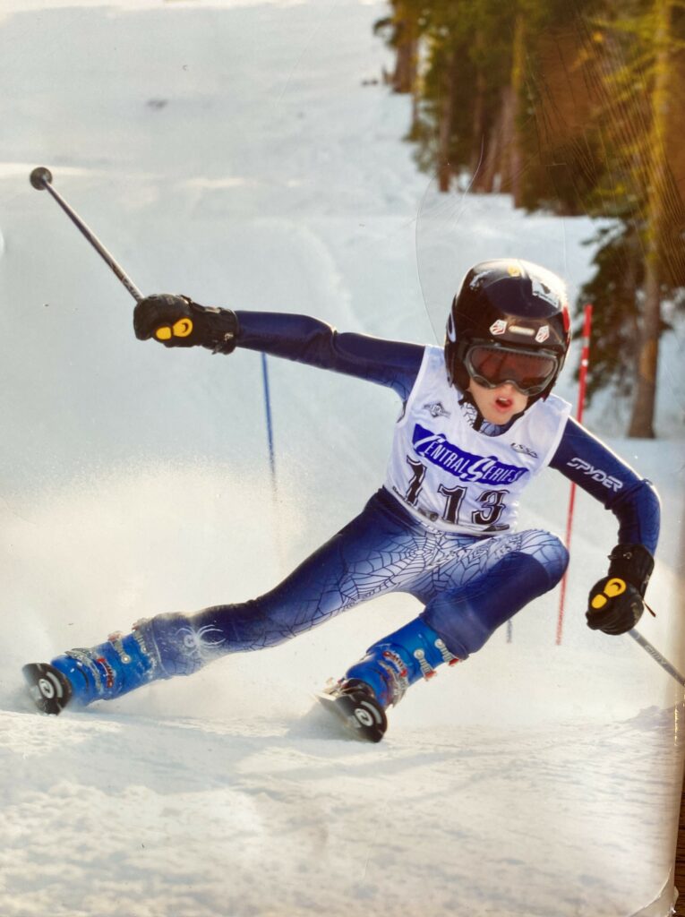 Young skier racing down slope